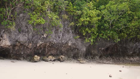 Carved-Limestone-Cliffs-With-Green-Trees-At-The-Empty-Beach