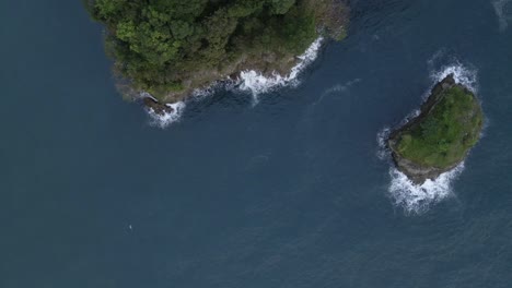 Aerial-high-angle-view-trucking-sideways-along-the-rugged-and-rocky-coast-of-central-America