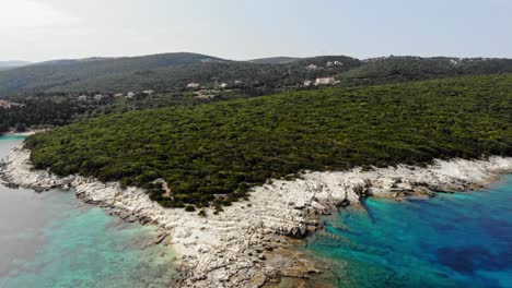 Rocky-Coastline-With-Green-Vegetation-At-Alexia-Beach-In-Erisos,-Greece