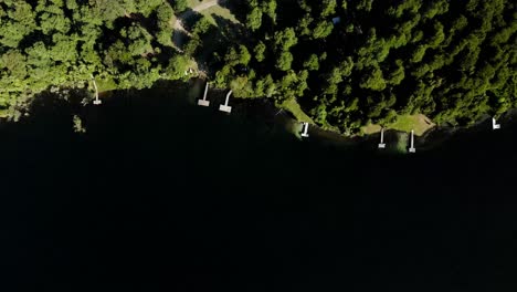 Top-view-of-all-the-small-docks-on-the-shore-of-tinquilco-lake---aerial-shot