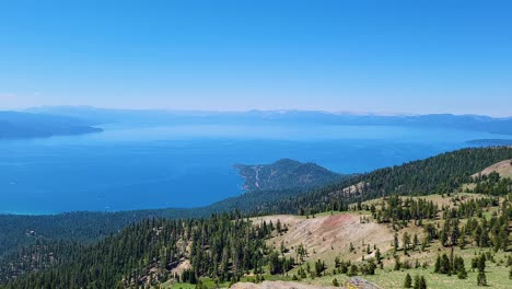 Crystal-Clear-Bright-Blue-Water-of-Lake-Tahoe-Surrounded-by-Pine-Tree-Forest-and-Mountains-Views-During-A-Hike-In-California