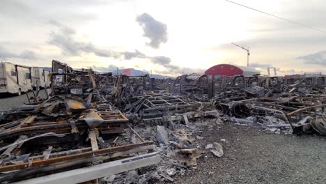 Tracking-shot-Junkyard-view,-many-vehicles-destroyed-by-fire,-Abbotsford,-British-Columbia