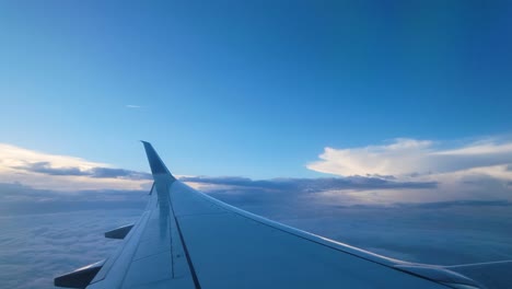 Flugzeugflügel-Gegen-Blauen-Himmel-Mit-Wolken-Während-Des-Fluges-Tagsüber
