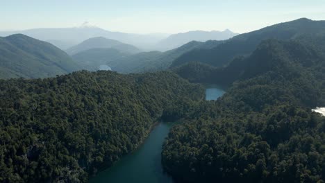 Panoramic-view-of-huerquehue-national-park-with-the-lagoons-chico,-verde,-toro-and-tinquilco-between-araucaria-forests-and-the-volcano-villarrica-in-the-background---aerial