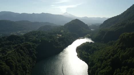 Drohnenaufnahme-Der-Lagune-Von-El-Leon,-Umgeben-Von-Bergen-Im-Hintergrund-Des-Vulkans-Villarica-An-Einem-Sonnigen-Tag---Antenne