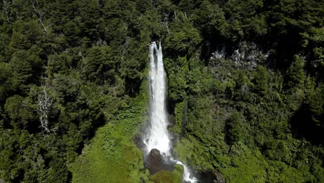 Dolly-in-of-the-waterfall-el-salto-el-leon-surrounded-by-vegetation-and-with-a-constant-rainbow---crane-shot