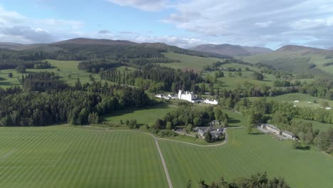 High-aerial-shot-and-push-in-towards-Blair-Castle-over-green-fields-and-gardens
