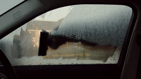 Scraping-ice-off-car-window-internal-view