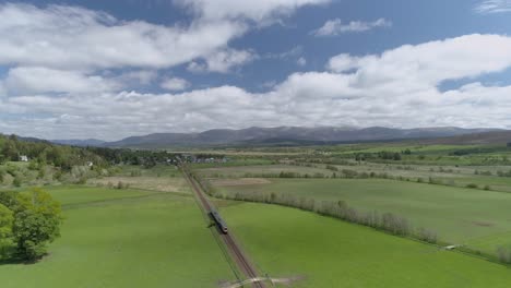 Aerial-follow-shot-of-a-Scotrail-Train-heading-towards-Newtonmore-in-Scotland