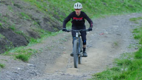 A-mountain-biker-is-blasting-down-a-hill-in-slow-motion