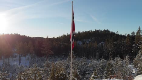 Norwegische-Flagge-Auf-Der-Stange,-Die-Im-Winter-In-Norwegen-Auf-Schneebedeckten-Bergen-Steht