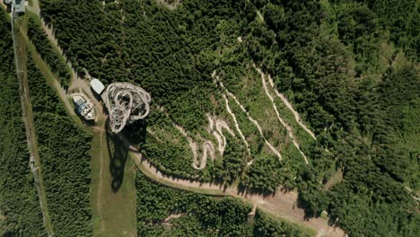 Aerial-birds-eye-view-of-a-sky-walk-tower-attraction-in-Dolni-Morava,-Czech-Republic-and-a-nearby-MTB-bicycle-trail