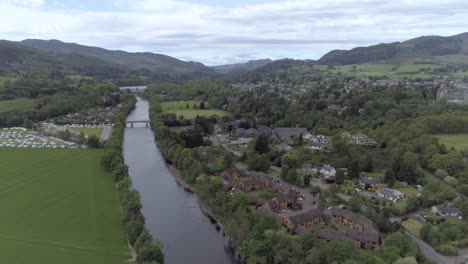 Aerial-push-in-shot-over-the-town-of-Pitlochry-and-the-River-Tay-in-Scotland