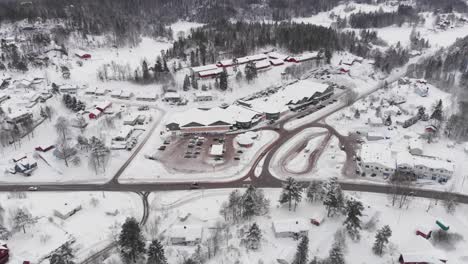 Beautiful-Snow-Covered-Norwegian-Town-And-Highway---aerial-shot