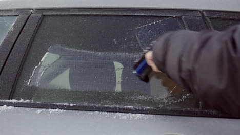 Scraping-ice-off-tinted-car-window