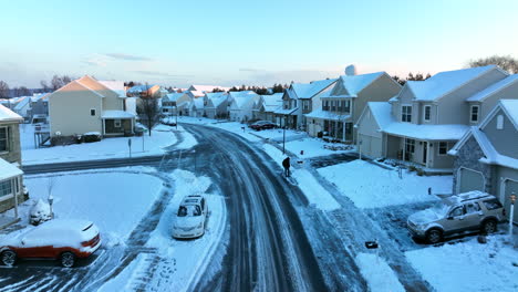 Aerial-of-neighborhood-housing-covered-in-winter-snow
