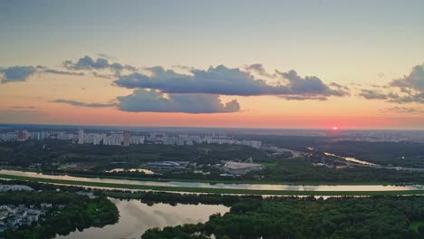 Flight-Over-Resort-Area-Of-City-With-Ponds-And-Natural-Parklands-At-Sunset-Time