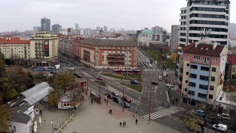 Ascending-aerial-shot-of-Racianske-myto-intersection-in-Bratislava-old-town,-Slovakia-on-overcast-day
