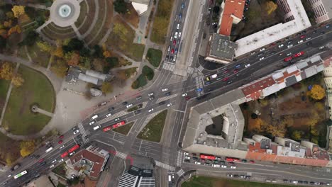 Wide-Aerial-descending-top-shot-of-cars-traffic-driving-Racianske-myto-intersection-in-Bratislava,-Slovakia