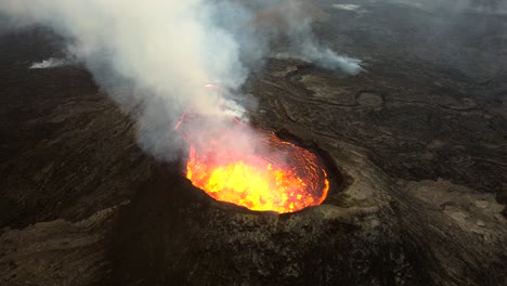 Aerial-footage-from-Fagradallsfjall-vulcano-in-Iceland,-the-lava-is-heavily-bubbling-in-the-crater