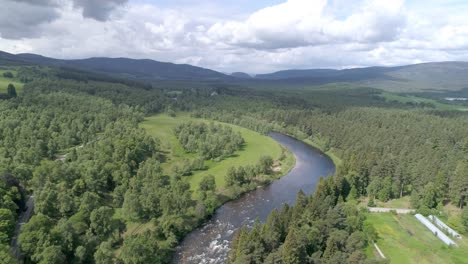 Aerial-push-in-over-the-River-Dee,-countryside-and-trees-in-Aberdeenshire