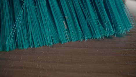 Macro-shot-of-broom.-Sweeping-the-floor
