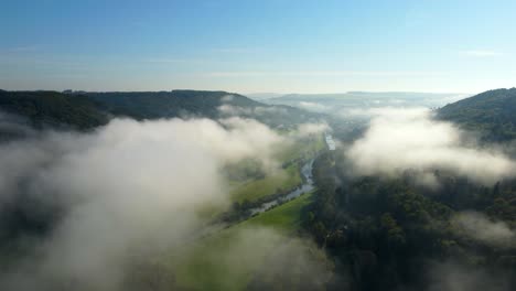 Aerial-footage-from-river-on-the-countryside-of-Luxembourg-on-a-sunny-day-while-clouds-are-passing-above-the-river