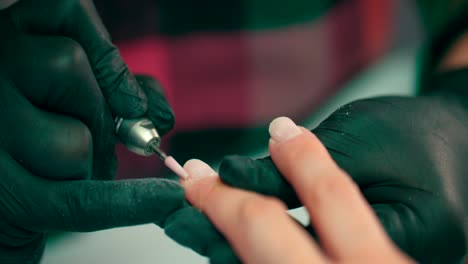 A-manicurist-grinds-nails-with-a-manicure-machine