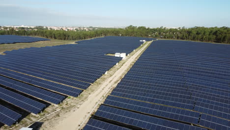 Aerial-Orbiting-view-of-solar-power-station-surrounded-by-forest,-Portugal
