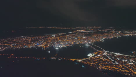 Aerial-view-of-Tromso-city-in-Norway-at-night-from-Fjellheisen-viewpoint
