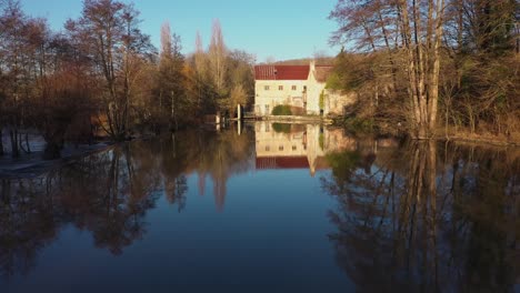 bird-fly-over-a-house-on-a-river-in-normandy