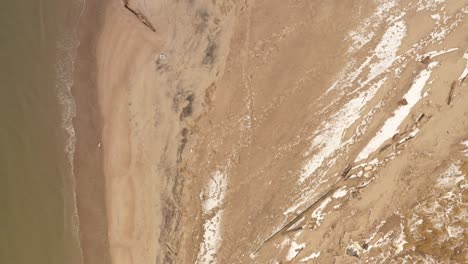 A-top-down-view-directly-above-empty-beach-of-Coney-Island-Creek-on-a-winter-day