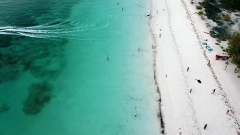 Amacing-slowly-sinking-down-fly-forwards-drone-shot-over-jet-sky-beach
