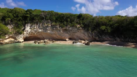 Sea-caves-on-deserted-beach-in-idyllic-Caribbean-sea
