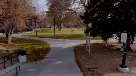 Pull-back-on-sidewalk-in-park-in-downtown-Reno,-Nevada-on-the-Truckee-River
