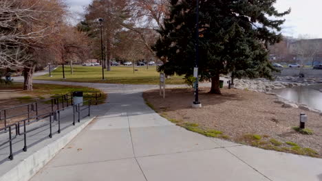First-person-view-down-walkway-in-park-on-a-winter-day-in-Reno,-Nevada