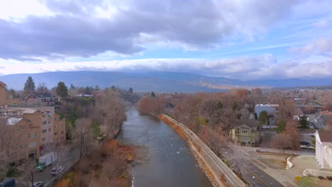 Aerial-of-the-Truckee-River-in-Reno,-Nevada-with-a-slow-descent-down