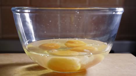 Raw-Eggs-Being-Poured-Into-A-Glass-Bowl