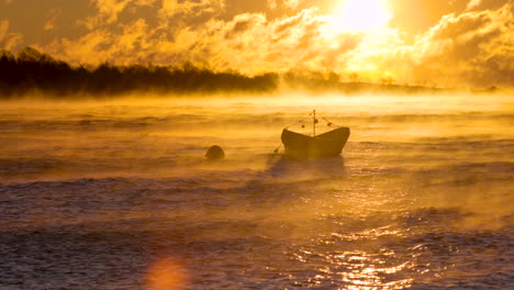 Wind-and-golden-steam-whip-across-an-anchored-rowboat-during-a-freezing-subzero-sunrise