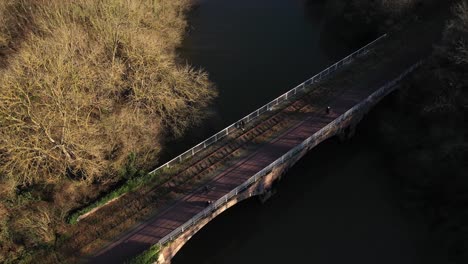 Aerial-view-of-a-bridge-on-the-greenway-of-Normandy-with-bicycles