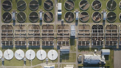 Aerial-top-down-shot-of-a-huge-biological-wastewater-treatment-plant-on-evening