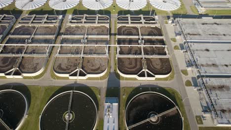 Aerial-trucking-shot-of-the-aeration-basins-and-the-clarifier-tanks-in-a-huge-biological-wastewater-treatment-plant