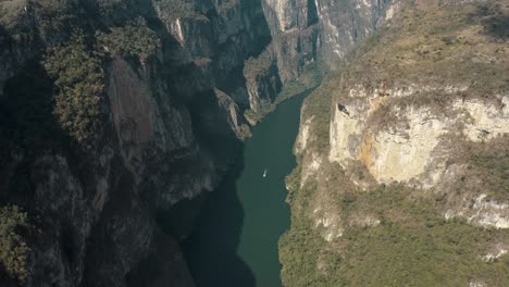 Aerial-top-down-shot-of-massive-Sumidero-Canyon-with-boat-cruising-on-Grijalva-River-in-Mexico