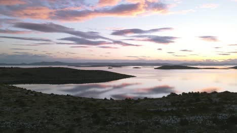 Sunset-clouds-reflected-on-calm-sea-waters,-Kornati-archipelago,-National-Park