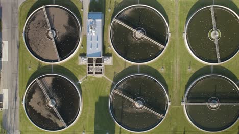 Aerial-top-down-shot-of-the-clarifier-tanks-in-a-huge-biological-wastewater-treatment-plant-purifying-water