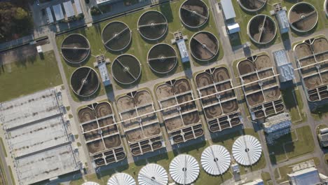 Aerial-descending-rotating-shot-over-the-aeration-basins-and-sedimentation-tanks-in-the-huge-wastewater-treatment-plant