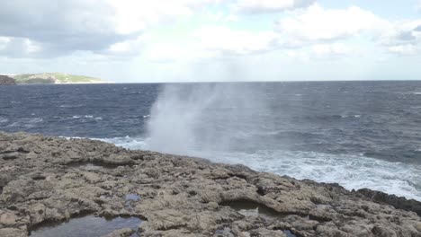 Geyser-of-Water-Splashes-near-Coral-Lagoon-Cave-in-Malta-on-Bright-Sunny-Day-in-Winter