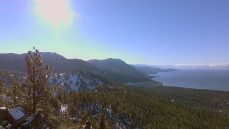 Aerial-view-of-Lake-Tahoe-with-mountains-and-Douglas-Firs-on-a-beautiful-winter-day