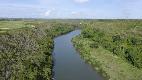 Aerial-flyover-Chavon-River-located-to-the-east-of-the-Dominican-Republic-at-sun