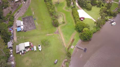 Top-down-aerial-fly-over-a-camping-site-next-to-a-river-at-Gold-Coast,-Queensland-Australia